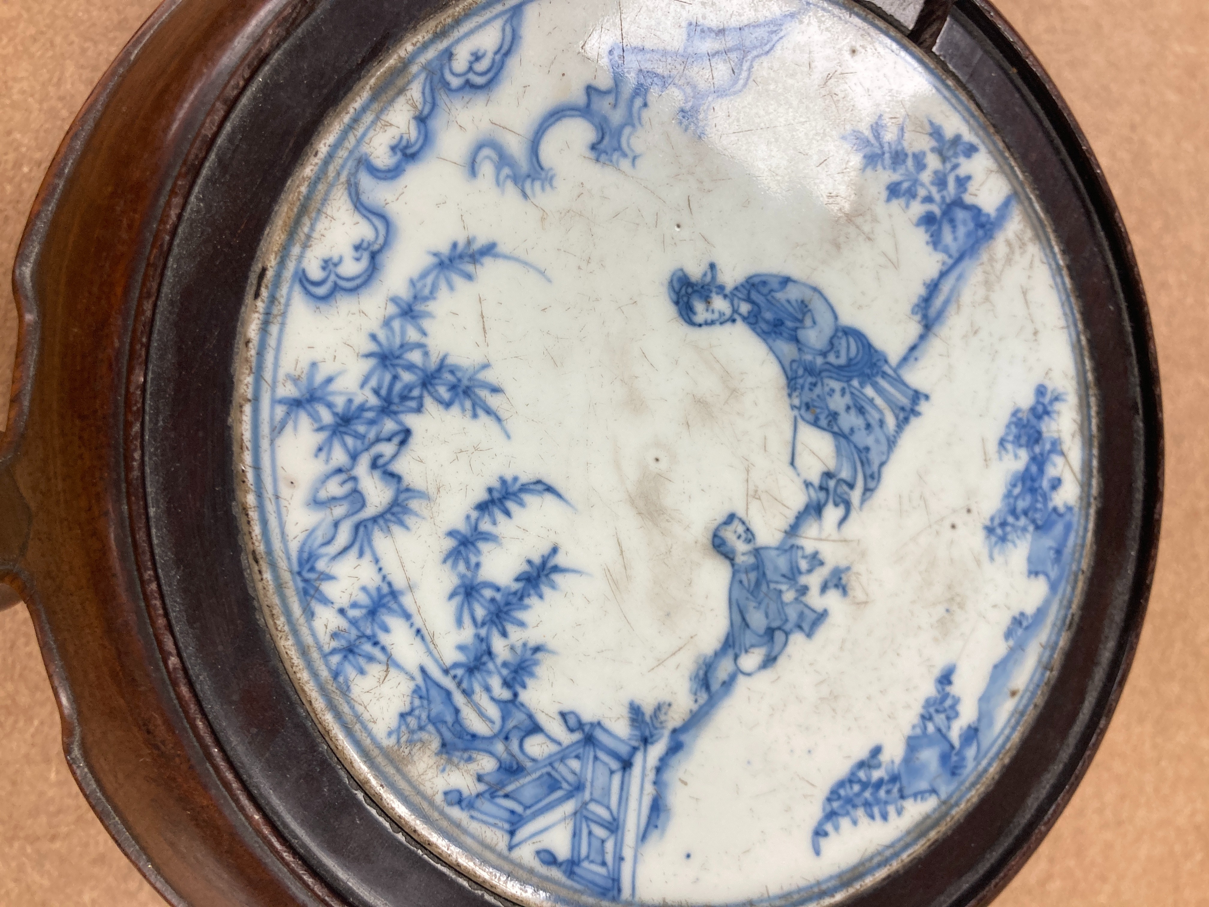 A 19th century Chinese blue and white circular tile inset hongmu stand, 22cm